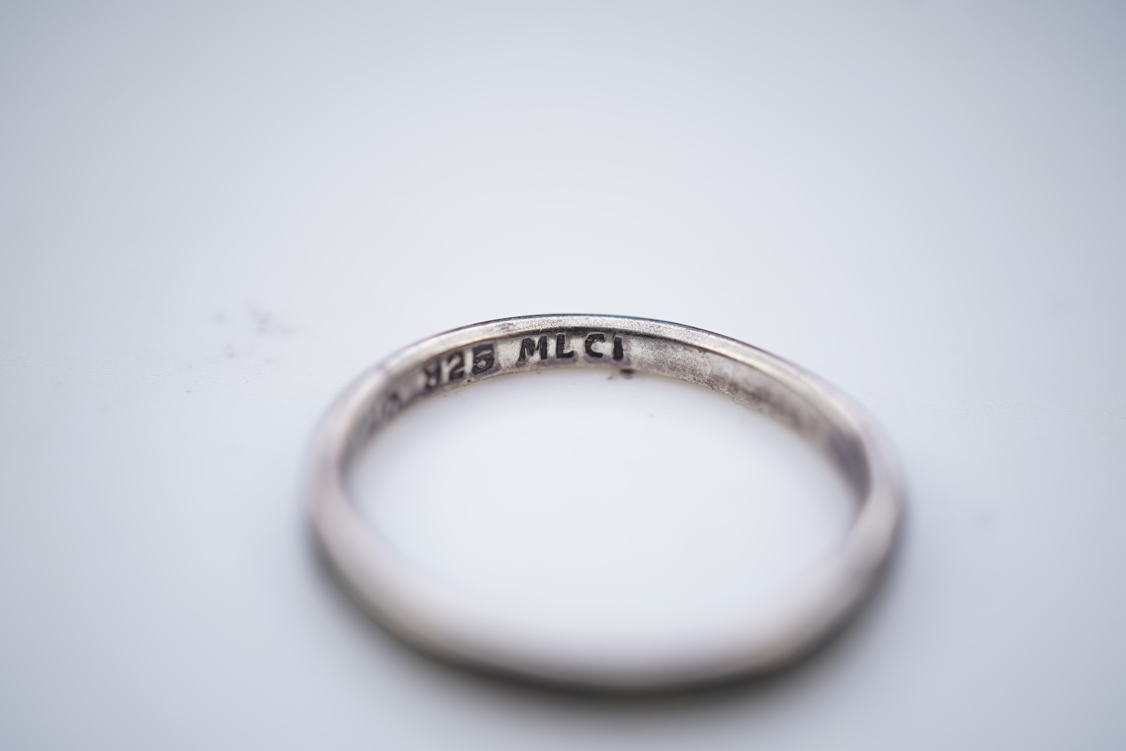 A collection of silver jewels, comprising: a bangle; a chain necklace suspending two winding toothpicks, one with toothpick deficient; a rope twist chain; a pair of cufflinks with the initials DBH; a pendant of abstract